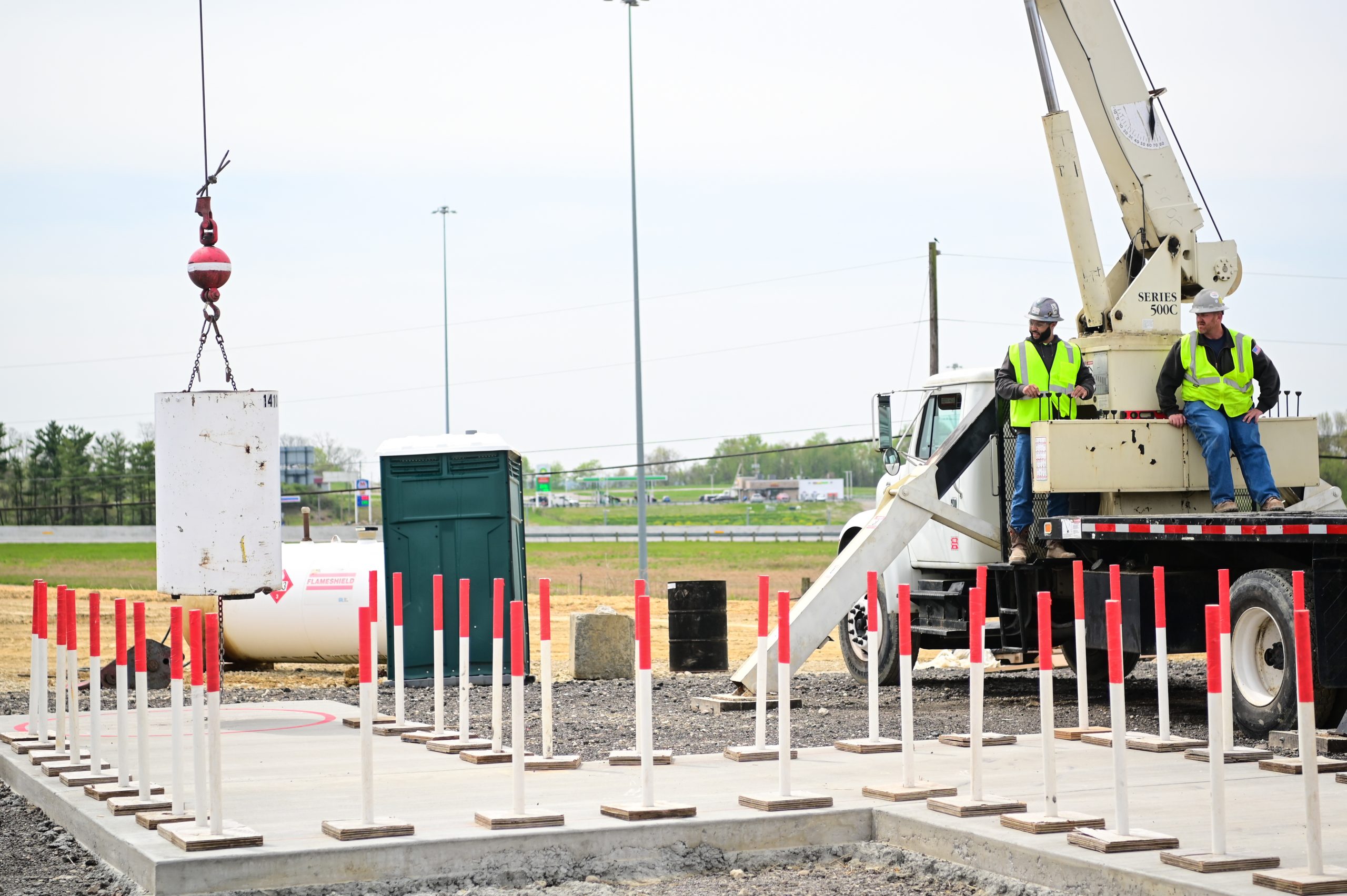 Crane operators at work on a construction site and they demonstrate that a crane operator is a good job